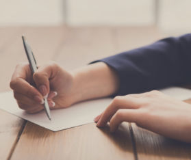 Woman Signing Papers