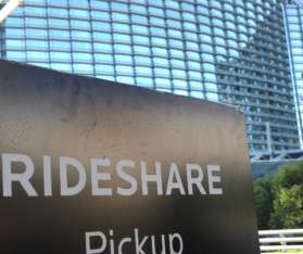 ride share pick up sign in front of a building